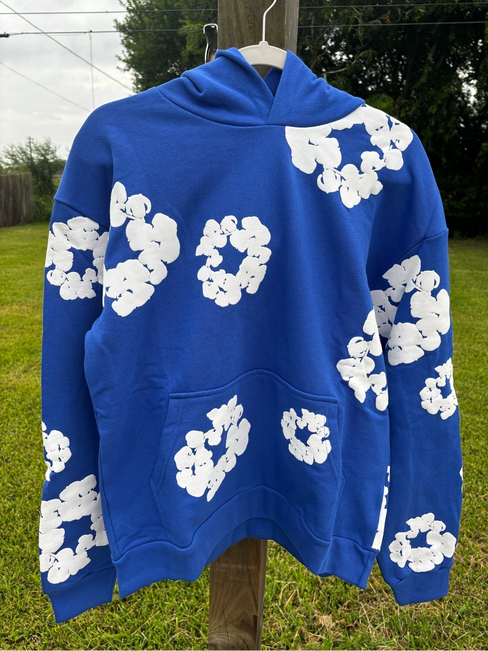 Blue Denim Tears Hoodie with White Floral Ring Prints